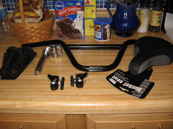 Black bicycle handlebars, seat, and grips on a countertop