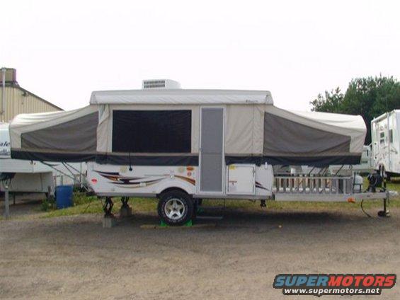 Pop-up camper trailer with extended canvas sections and a door on the side