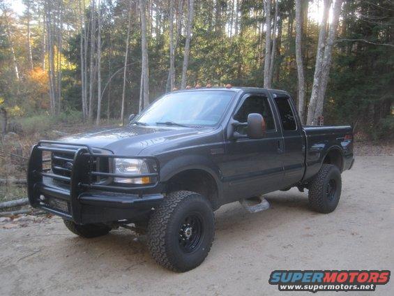 Dark gray 2003 Ford F-350 pickup truck with brush guard and lifted suspension