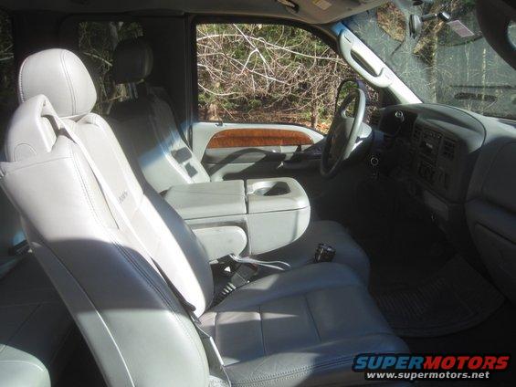 Gray leather interior of a 2003 Ford F-350, showing front seats and dashboard