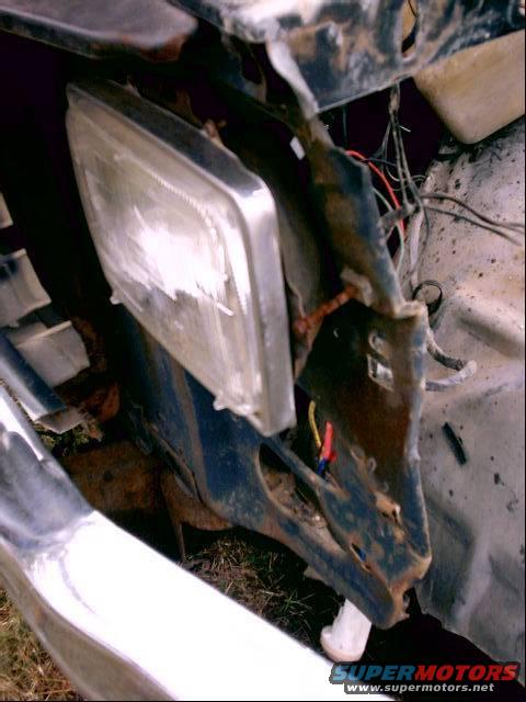 Headlight and damaged fender with exposed wiring