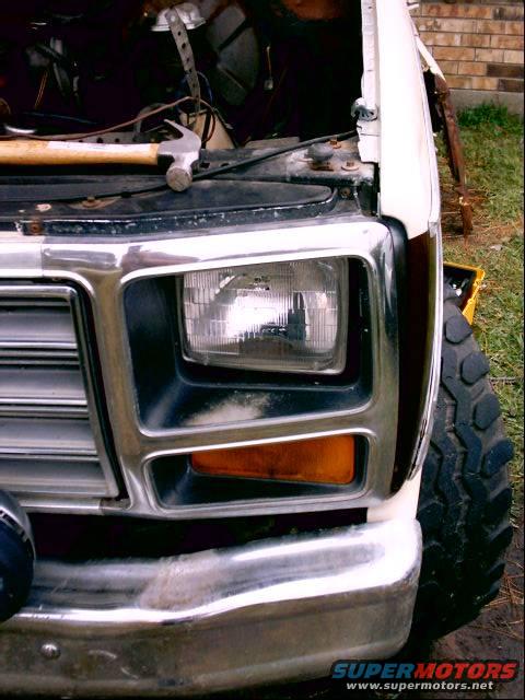 1980 Ford Bronco front fender and headlight with a hammer on the hood