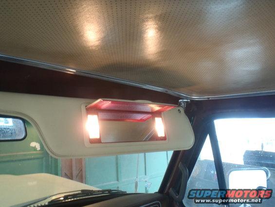 Interior view of 1979 Ford Bronco with illuminated vanity mirror and beige headliner