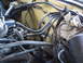 1973 Ford Ranchero - Close-up view of an engine bay with numerous hoses and wires, showing the firewall and some electrical parts.