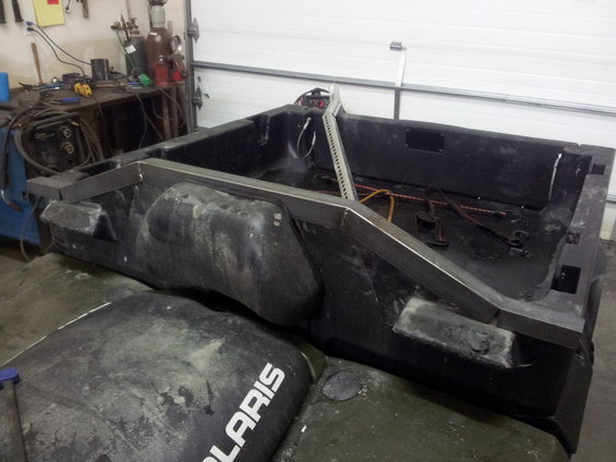 ATV cargo bed with metal frame modifications, "POLARIS" visible