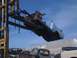 1964 Ford Ranchero - Junkyard forklift lifts a 1964 Ford Ranchero body over other scrap vehicles.