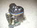 2004 Ford F-350 - A black fuel injection pump with a gear is shown against a textured background.