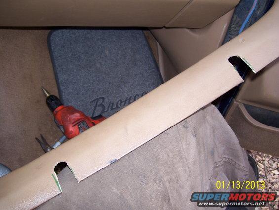 Interior trim panel, drill, and floor mat with 'Bronco' text