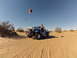 1970 Volkswagen Beetle - A modified blue Volkswagen Beetle, known as a Baja Bug, sits in a sandy desert landscape under a clear blue sky.