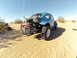 1970 Volkswagen Beetle - A modified Volkswagen Beetle, known as a Baja Bug, is parked in a sandy desert landscape.