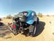 1970 Volkswagen Beetle - A modified blue 1970 Volkswagen Beetle, known as a Baja Bug, sits in a sandy desert environment with its engine exposed.