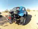 1970 Volkswagen Beetle - This custom Baja Bug features an exposed engine, a prominent exhaust pipe, and off-road tires, ready for desert terrain.