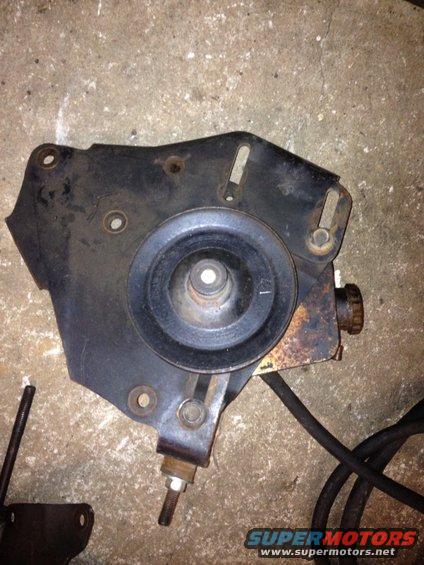 Power steering pump bracket with pulley, on concrete floor