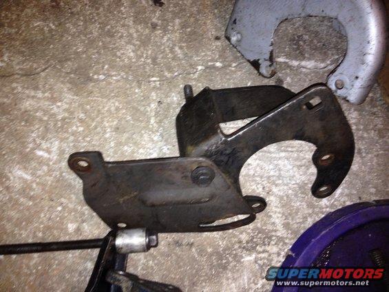 Metal bracket with bolt holes on a concrete floor