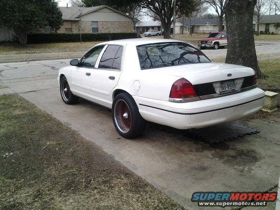 White 2000 Ford Crown Victoria rear view with custom wheels