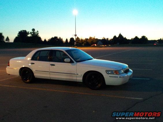 White 2000 Mercury Grand Marquis parked in a lot at dusk