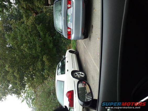 2000 Mercury Grand Marquis parked next to a silver sedan