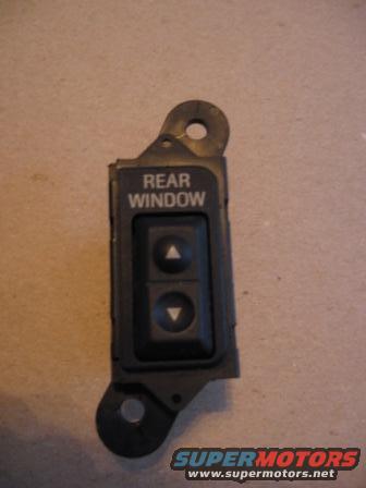 Black plastic rear window switch with up and down buttons and mounting tabs