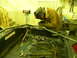 1990 Chevrolet Suburban - A person is welding a metal frame in a workshop with tools and equipment visible.