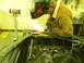 1990 Chevrolet Suburban - Grinding metal sparks fly as a person works in a workshop with various tools around.