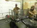 1990 Chevrolet Suburban - Two men are building a custom metal cargo rack onto the back of a Polaris ATV.