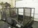 1990 Chevrolet Suburban - A utility vehicle with a custom metal cage is parked inside a garage with tools on a shelf in the background.