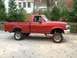 1996 Ford F-150 - A red 1996 Ford F-150 pickup truck is shown from the side, a lifted suspension and large tires.
