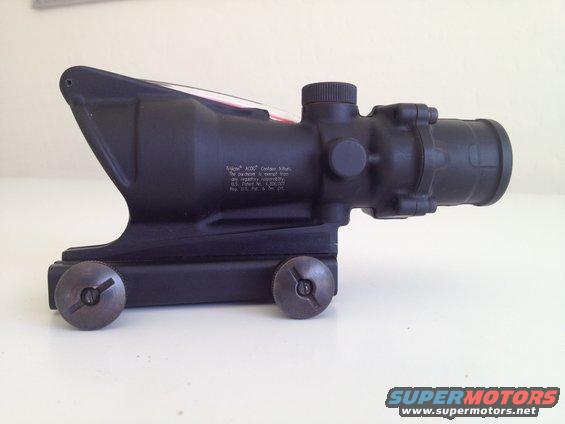 Black Trijicon ACOG scope with visible text and mounting screws
