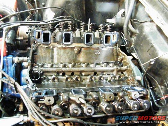 Engine block with cylinder heads removed, showing valves and springs