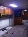 2003 Ford F-350 - Interior view of an RV showing the sleeping area, storage cabinets, and entertainment center.
