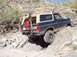 1993 Ford Bronco - This 1993 Ford Bronco navigates a challenging rocky terrain, equipped with off-road gear.