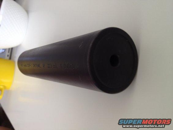Black suppressor with visible text and caliber marking