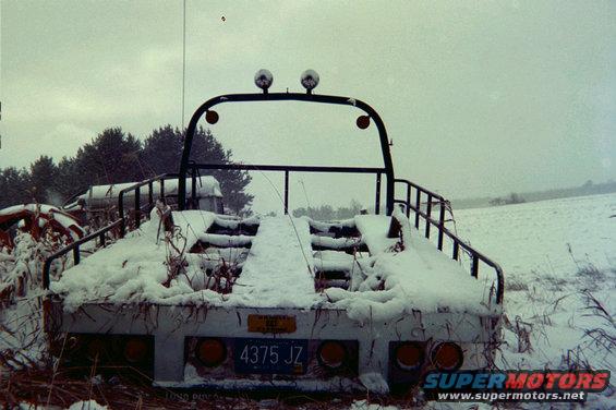 Tow truck bed with license plate 4375 JZ covered in snow