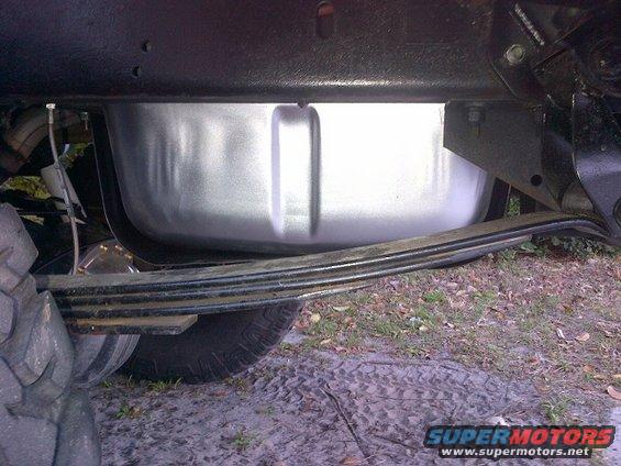 Underneath shot of a vehicle's fuel tank and leaf spring suspension system
