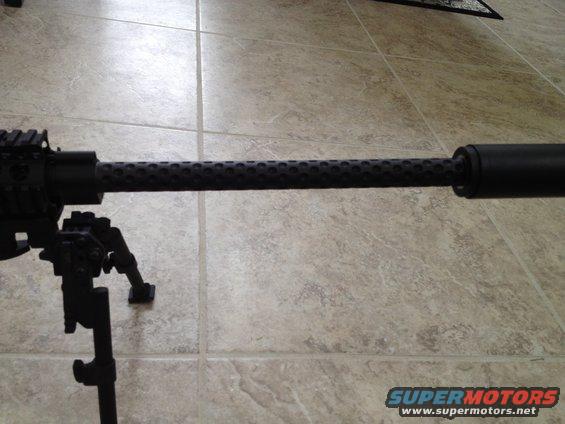 Black gun barrel with perforated shroud and bipod