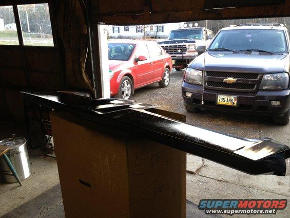 Black car part on box in garage