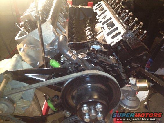 Black V8 engine block with chrome valve covers and a drive belt