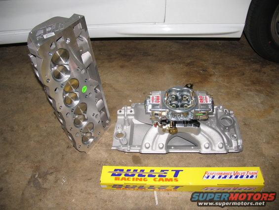 Aluminum cylinder head and intake manifold with carburetor, plus a box of Bullet Racing Cams
