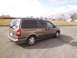 2005 Chevrolet Venture - Rear 3/4 view of a tan 2005 Chevrolet Venture minivan parked on asphalt.