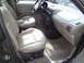 2005 Chevrolet Venture - The interior of a minivan shows the front passenger and driver seats, dashboard, and center console.