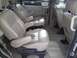 2005 Chevrolet Venture - The interior of this minivan features multiple rows of beige leather captain's chairs and a neutral carpeted floor.