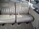 2005 Chevrolet Venture - Interior view of tan leather seats with visible seatbelts and a cup holder.