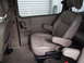 2005 Chevrolet Venture - The interior of a van shows tan leather captain's chairs with armrests and seatbelts visible.