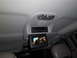2005 Chevrolet Venture - The interior of a vehicle shows an overhead entertainment system with a screen playing a movie and audio controls.