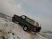 1992 Ford Bronco - Ford Bronco navigates a snowy hillside, showing its rear-mounted spare tire.