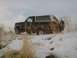 1992 Ford Bronco - A 1992 Ford Bronco sits in a snow-covered field, partially obscured by dry vegetation.