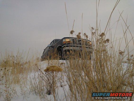 Dark 1992 Ford Bronco in snow, front 3/4 view