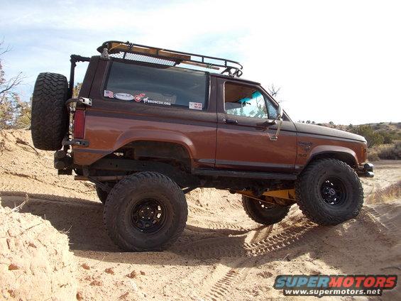 Brown 1986 Ford Bronco II with off-road tires on sandy terrain