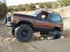 1986 Ford Bronco II - This modified 1986 Ford Bronco II is shown off-road, navigating sandy terrain.