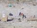 1986 Ford Bronco II - A scene of target practice with various items scattered across a dry, arid landscape.